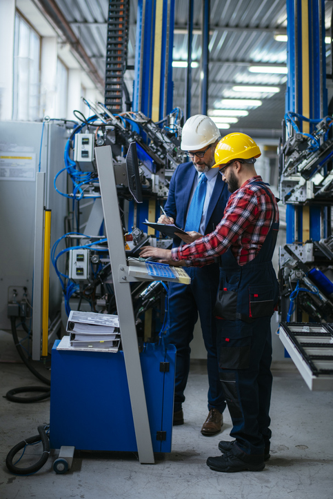 Ein Krawattentrager Mit Arbeiter Vor Maschine